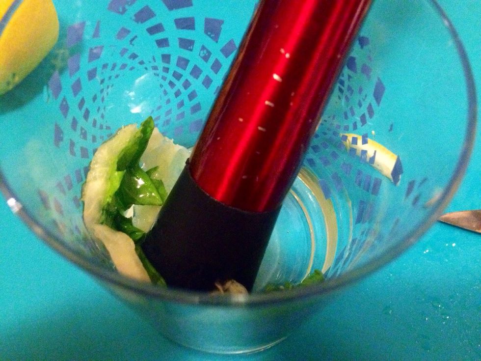 Muddle the lemon and mint leaves.