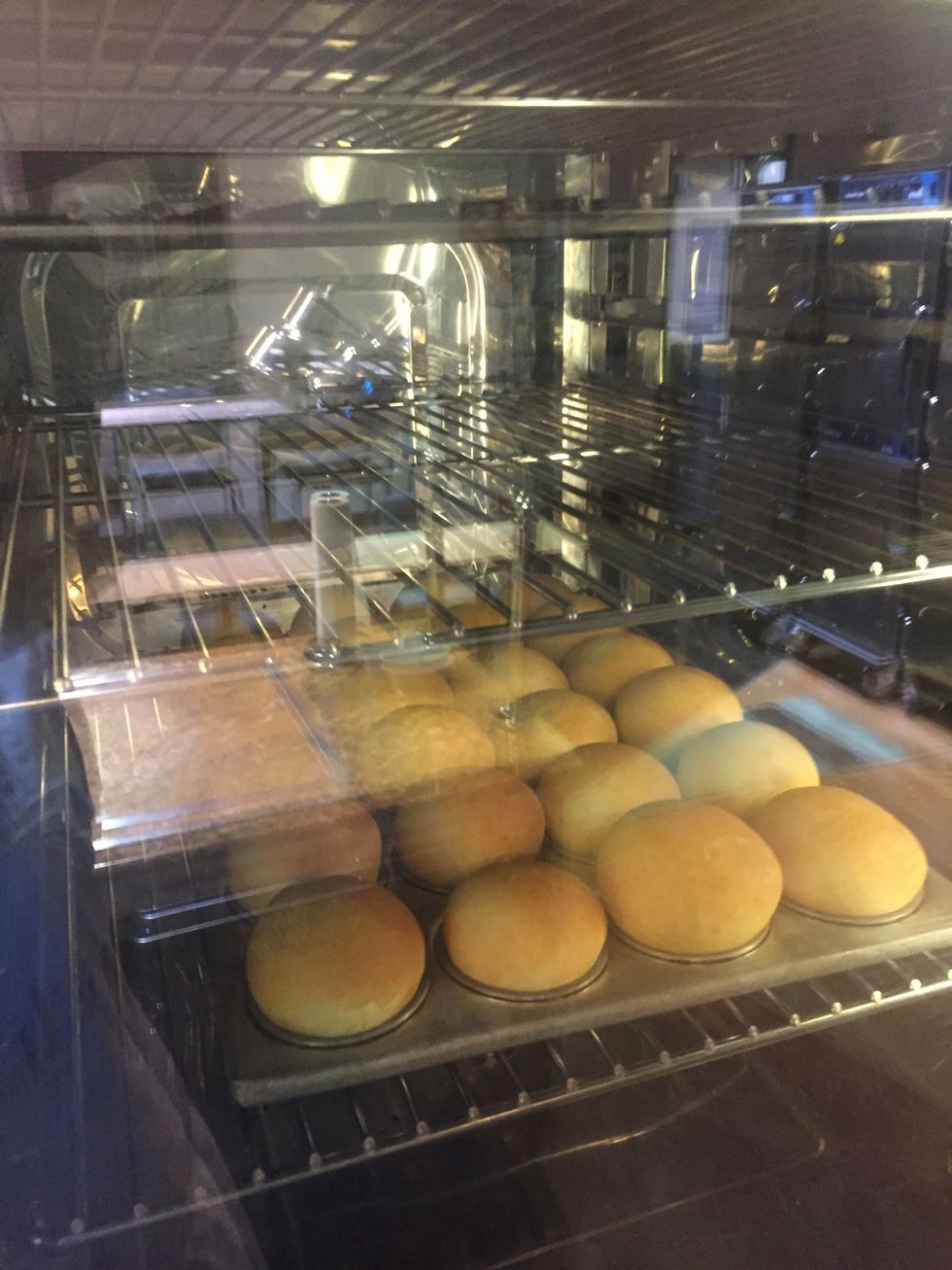 Muffin tin dinner rolls baking.