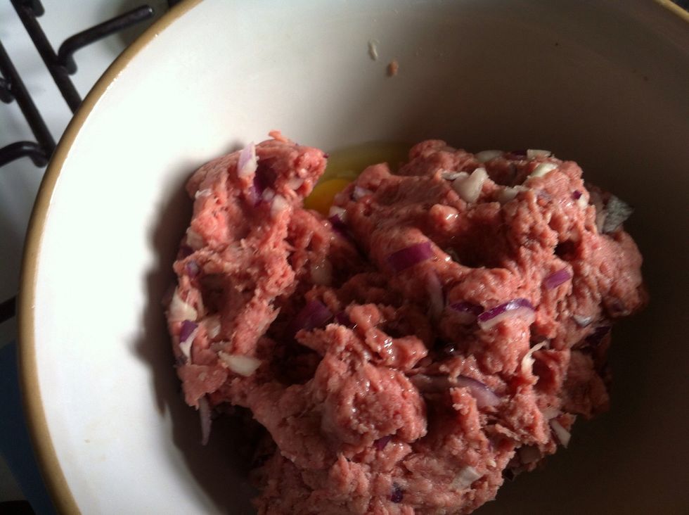 Mush together with your hands and then add one egg to bind the mixture together. Mush again to mix the egg in with the meat.