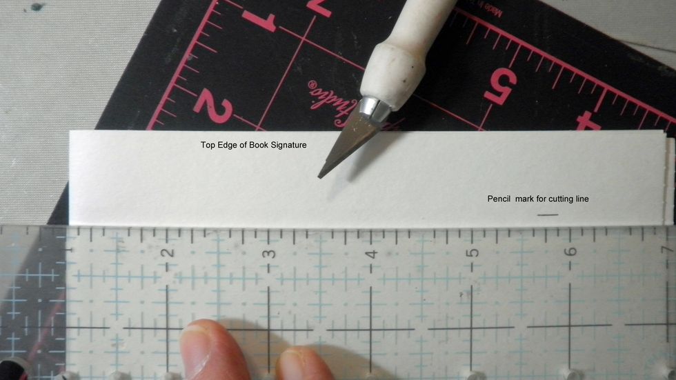 My book is shorter than my signatures, so I need to trim the top down to 7-\u00be" to fit inside the covers, which is approximately 1/4" shorter than the height of my book.