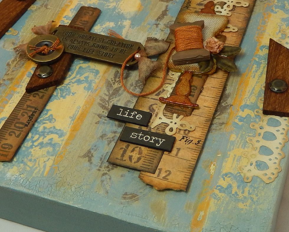 My canvas was finished with various sewing related paper strips, die cuts and metal embellishments. You could add your own choice of toppers at this stage.