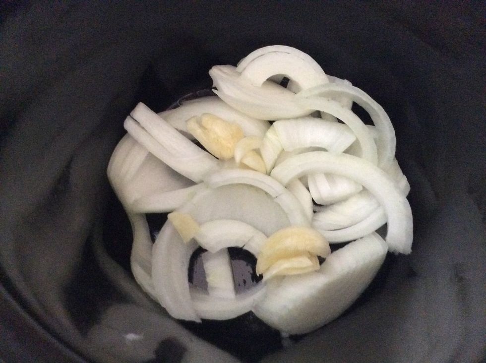 My crockpot is smaller but still this is how your onions and garlic should be at the bottom