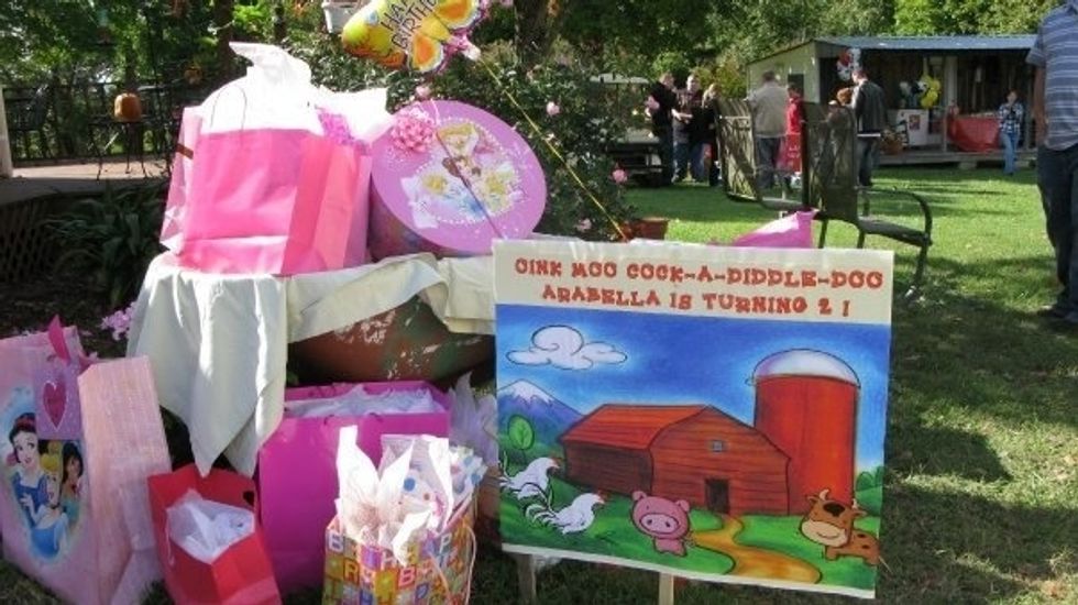 My daughter-in-law planned the perfect party for a 2 yr old. Everyone was told to wear western clothes and bandanas were party favors. Gifts were left in a wheel barrel and signage greeted guests.