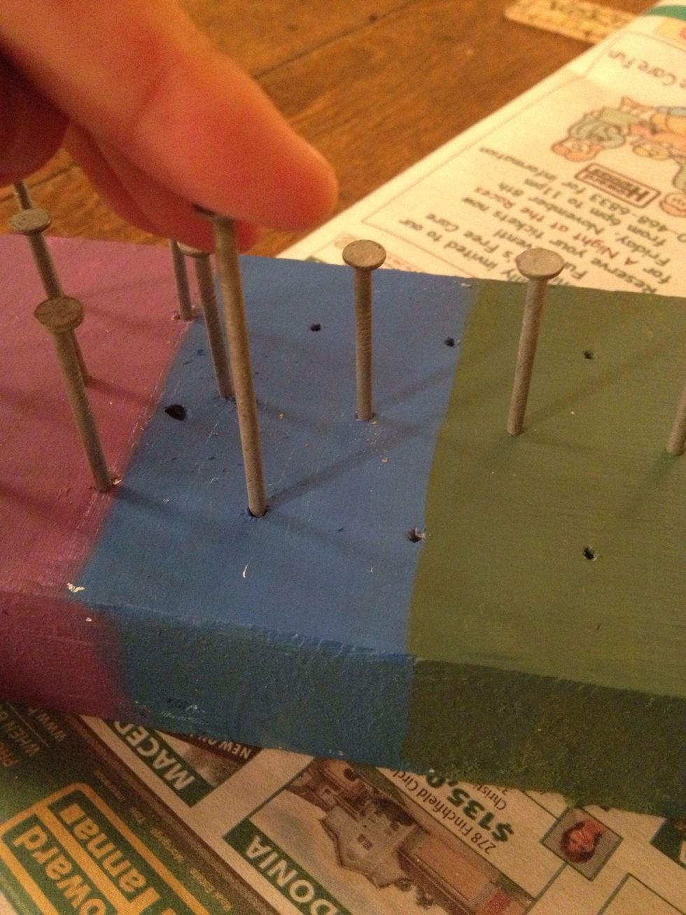 My daughter painted her loom but that is optional.  Start hammering your nails into your board. Be sure to get them in straight.