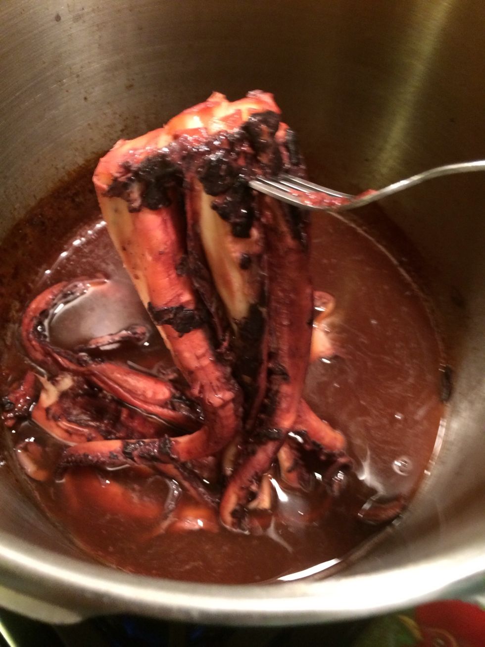 My pulpo is done you can tell by its rosy color & of course by testing it with a fork. It should be tender. I like mine al dente. If you like yours much tender keep cooking it ,but don't overcook it