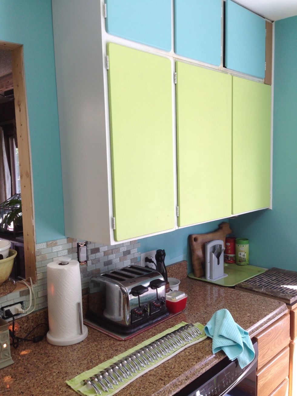 My re-painted cabinets woefully bare of their handles just waiting for their new but vintage bling!