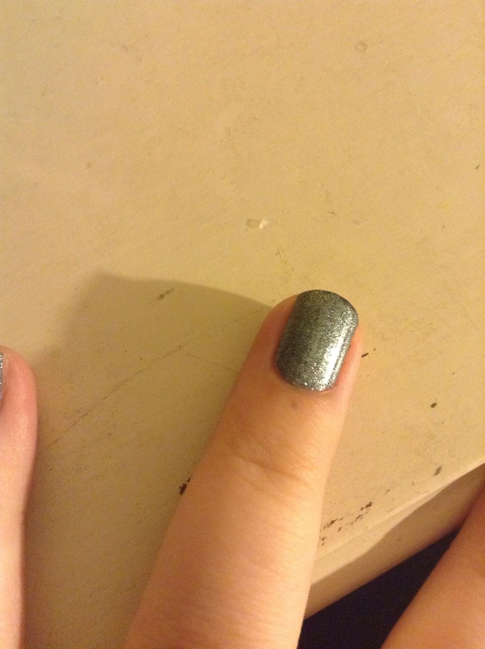 My ring finger I'm doing a triangle. Make a dot about in the middle of your nail. Do the same thing as before and make the lines to the side of your nail. I forgot to take a pic of the dot and lines.