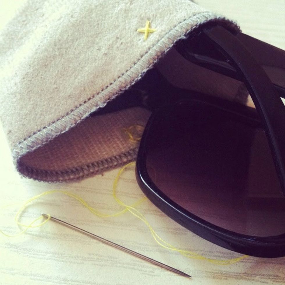 my sunglasses didn\u2019t want to stay inside their cover, so i quickly attached a snap fastener.  since I had to kill some time, this old boring pouch turned into a little hipster embroidery project: