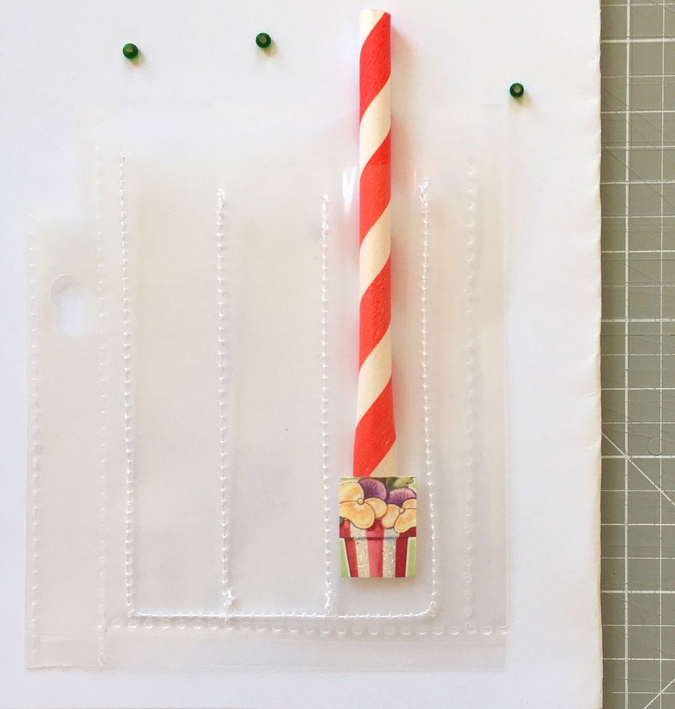 My trick is to use a piece of paper straw that I pinch at the end to push the items down. You can also use it to filter in the smaller sequins and seed beads into the slots.