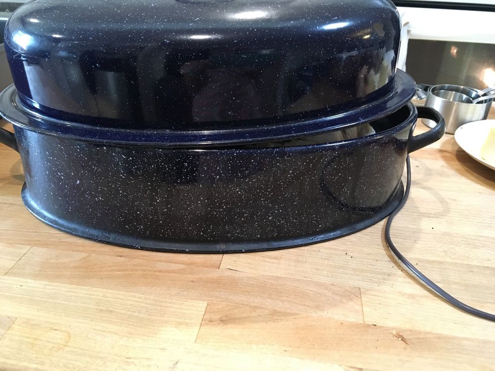 My turkey tray came with a topper. You don't have to do this but it makes the turkey not as burnt. I also put tin foil over the turkey.