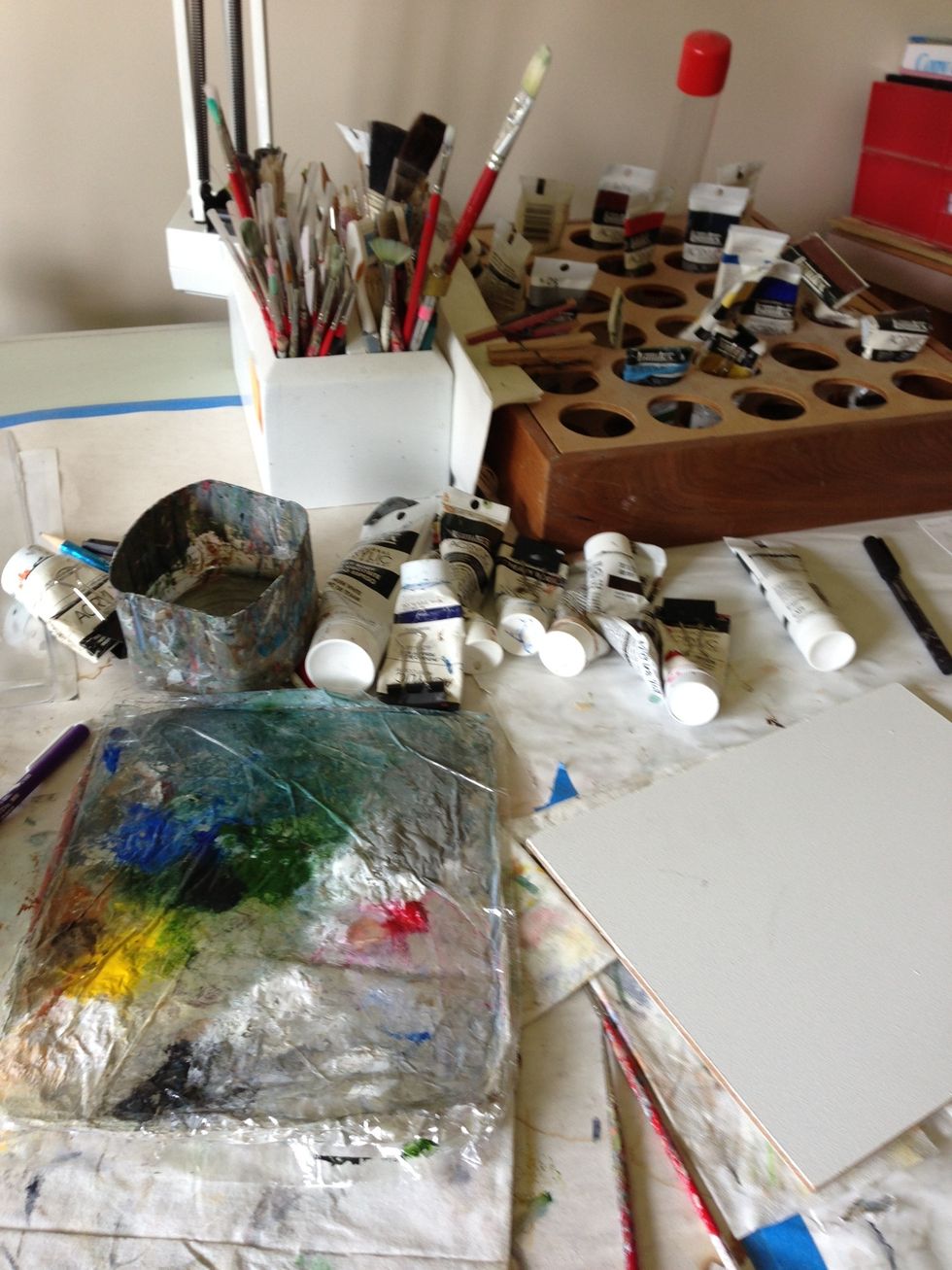 My work place...nothing fancy. My nice husband built me the paint and brush holders which work great. I do not paint vertically on an easel but prefer a drawing table with a slightly angled surface.