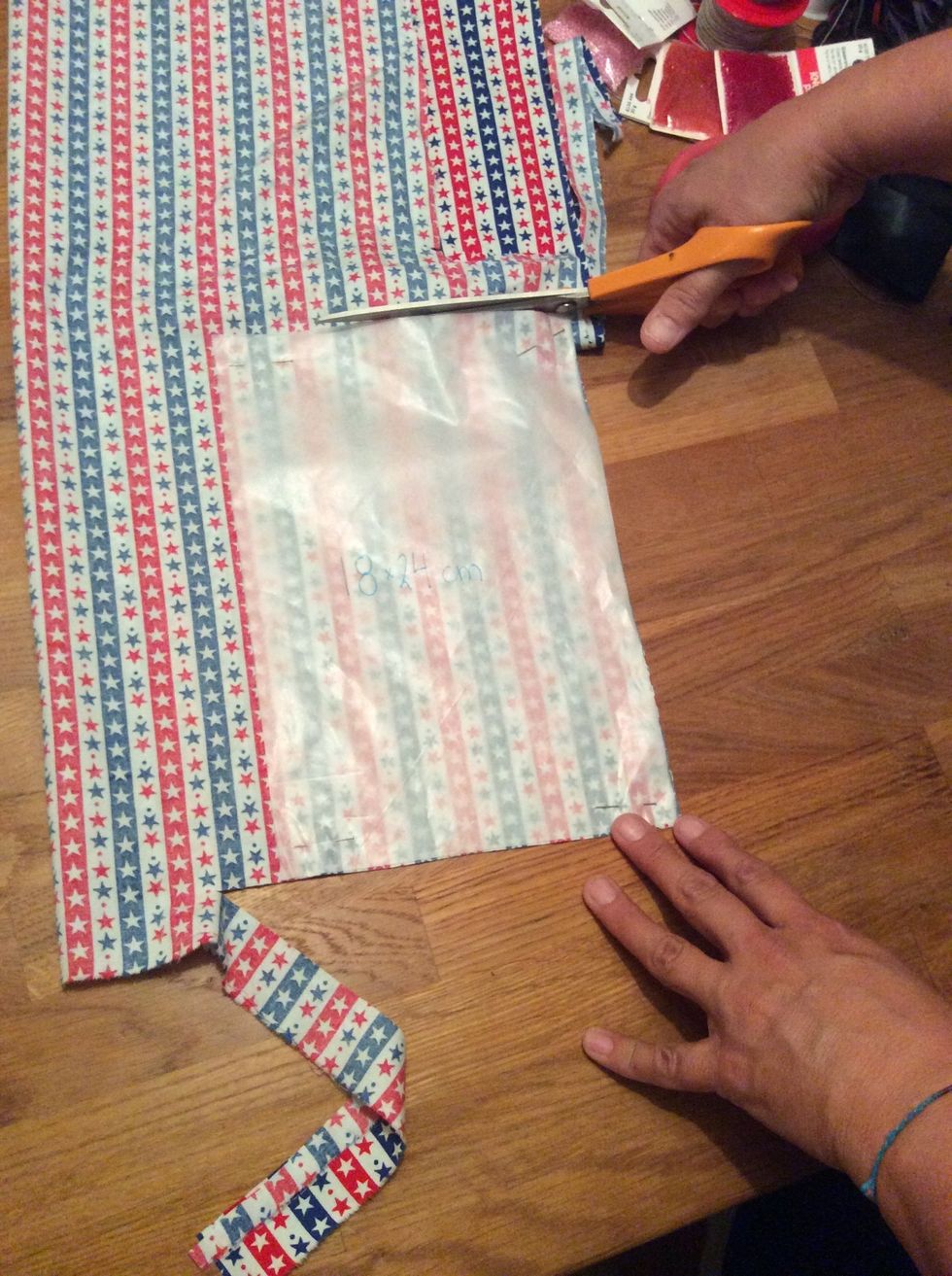 N\u00e5la fast pappersmallen p\u00e5 tygbitarna och klipp ut dem. Du ska ha 2 bitar av varje tyg.