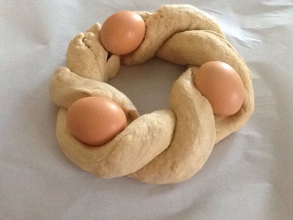 Nestle 3 eggs between twists in dough.