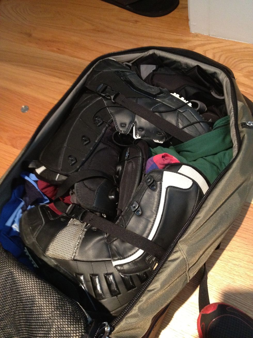 Never check your boots - they are the most critical piece of the snowboarding gear trifecta (boots/bindings/board). Place them in your carry-on and fill them with long underwear, socks, etc.