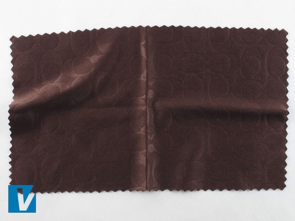 New Coach sunglasses are accompanied by a dust cloth featuring the repeated back to back CC logo. Check the spacing and positioning of the C's carefully.