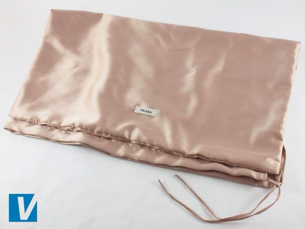 New Prada heels are accompanied by a branded dust bag. This most often features the 'PRADA' logo sometimes with 'Milano' and 'DAL 1913' all in capital letters.