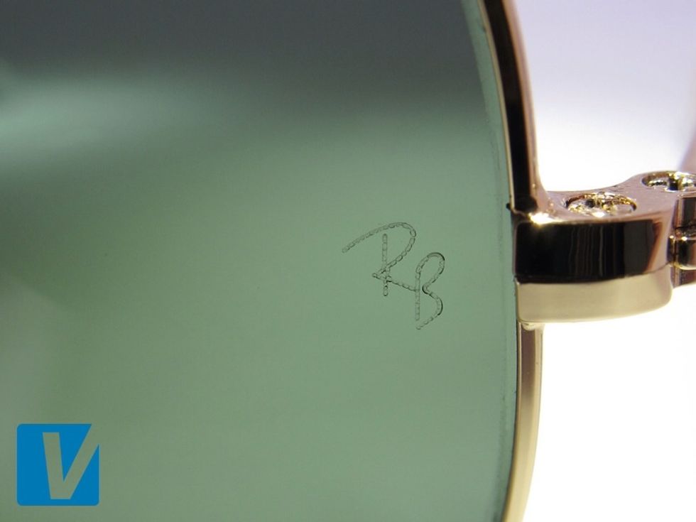 New Ray-Ban sunglasses feature a small 'RB' etched on the left lens just below the hinge. Compare the position, size & font very carefully. Pre 2000 models feature 'BL' for Bausch & Lomb.