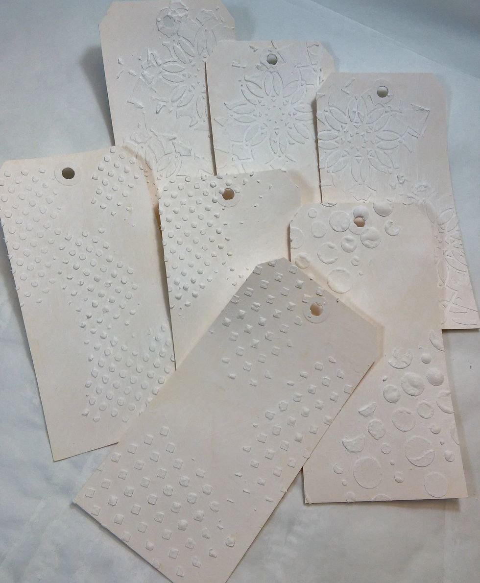 Next, a quick coat of gesso over the front of each one.