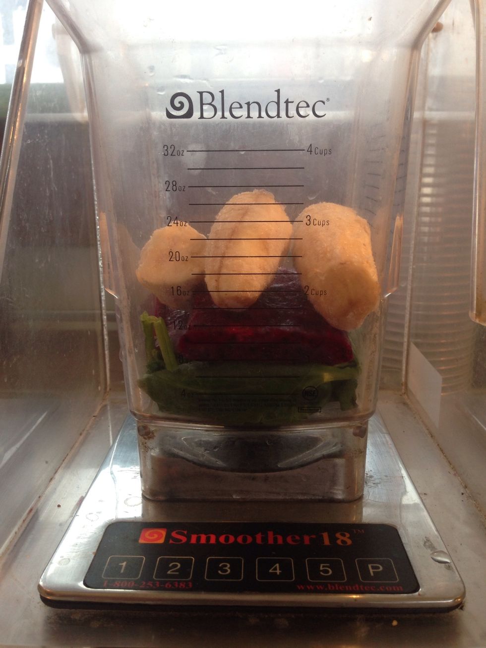 Next add 1/2 of a frozen banana in the blender. I prefer to chop it into pieces because it allows me to blend it better and faster.