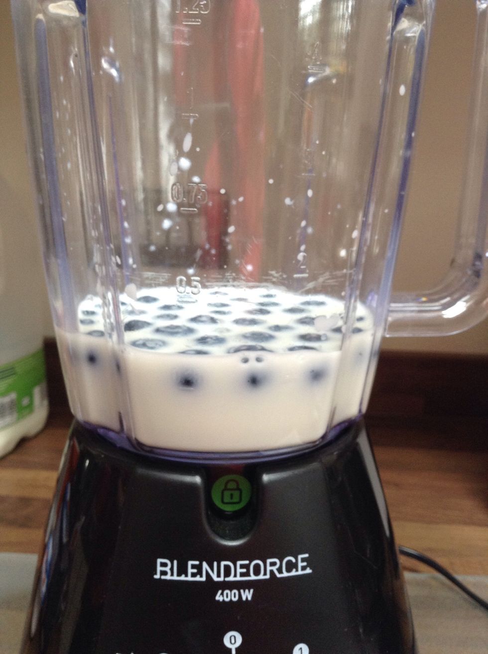 Next, add 25g of blueberries into the blender.