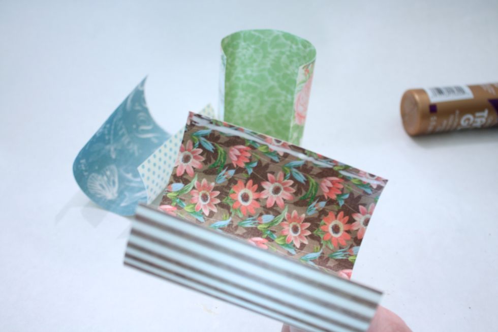 Next, add a bead of glue to one end of your curled up paper