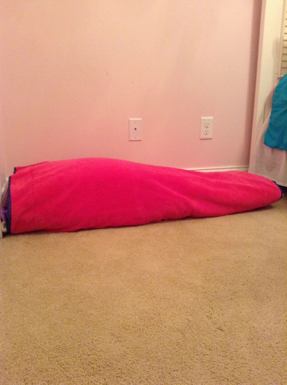 Next, add a decorative blanket on top. Try one that has a stylish pattern or color on both sides so you won't get bored with your area. Also, tuck in the blanket so it looks neater.