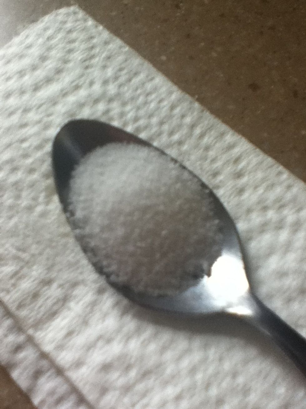 Next, add a little less than a spoon full of sugar.
