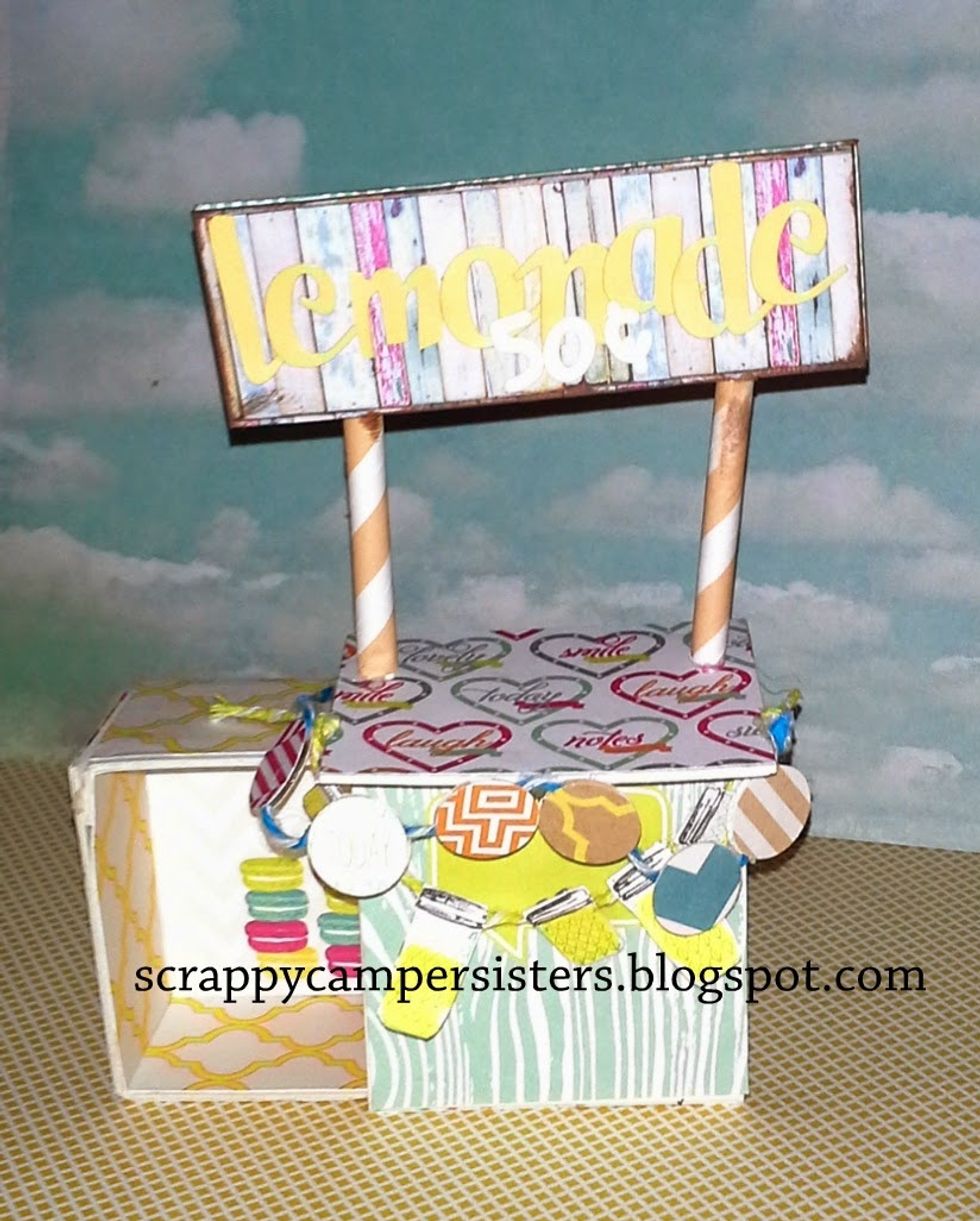 Next add a piece of baker's twine and fussy cut out mason jars with lemonade in them and adhere to the twine with a Tiny Attacher (mini stapler by Tim Holtz)