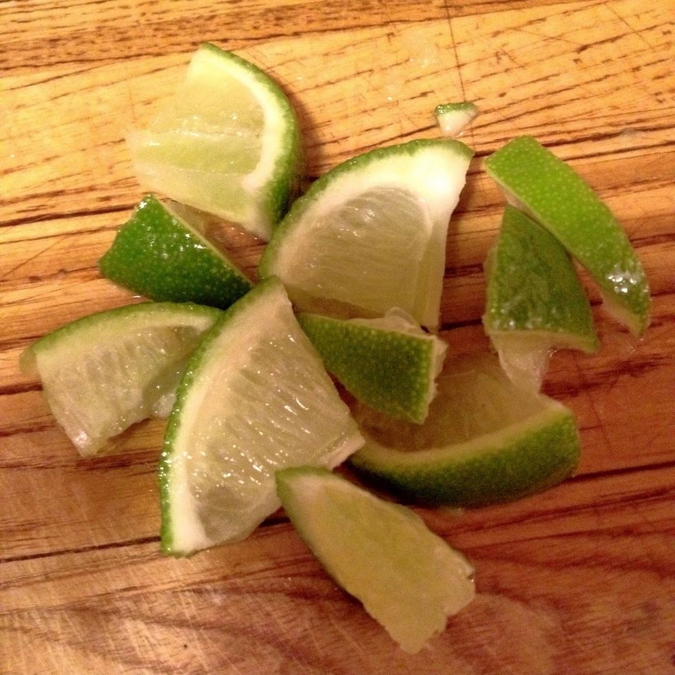 Next add about half a small lime to the cup. They should be cut like this in order to get the maximum amount of lime juice.