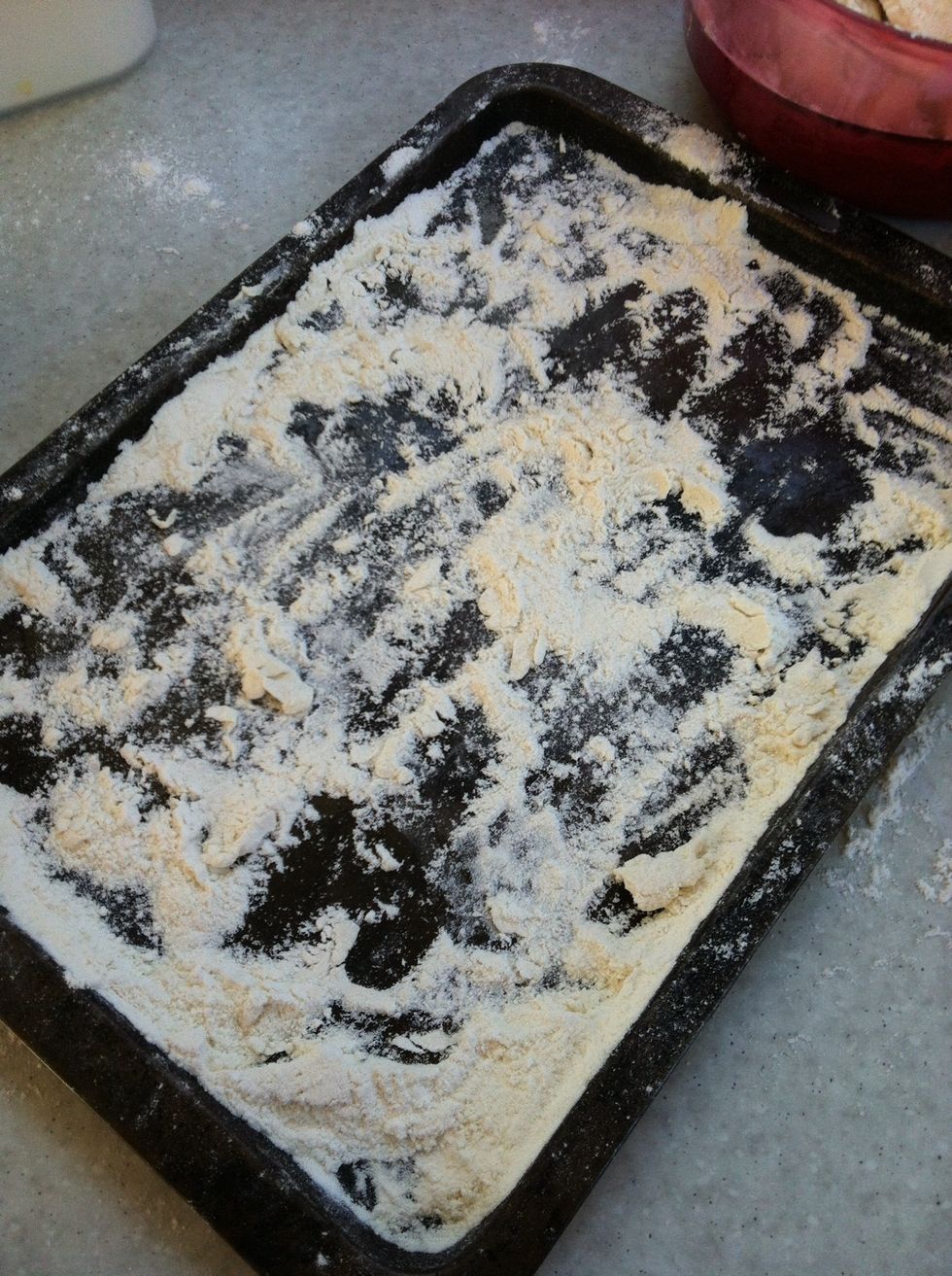 Next add flour to a baking tray