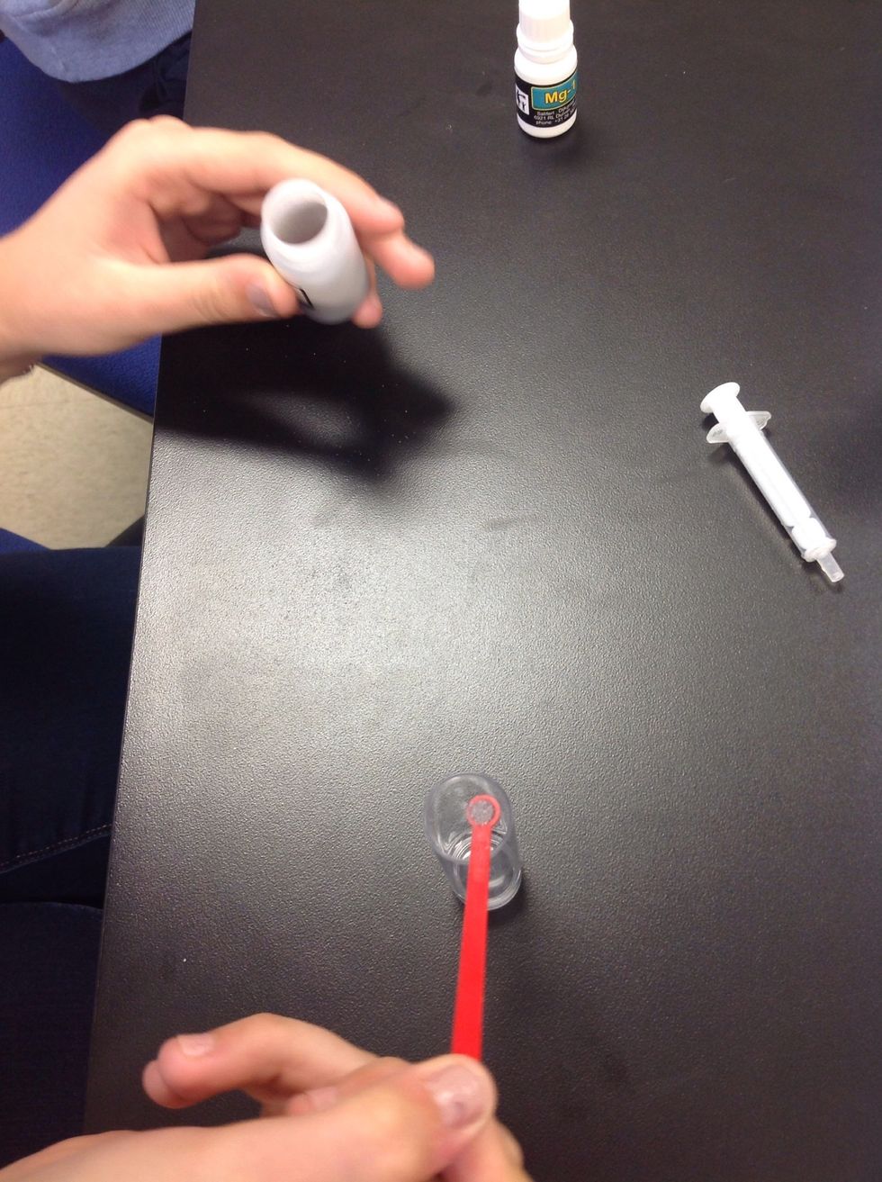 Next add one spoonful of the Mg-2 powder to the vile. Swirl to combine.