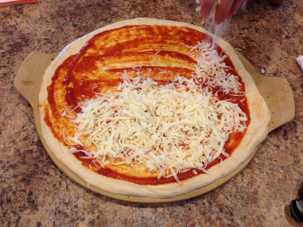 Next add shredded mozzarella cheese. I used about 3 cups for this pizza which is a 16" pizza. You can add as much or a little as you want! I will say.... To much can make your crust flimsy and greasy.