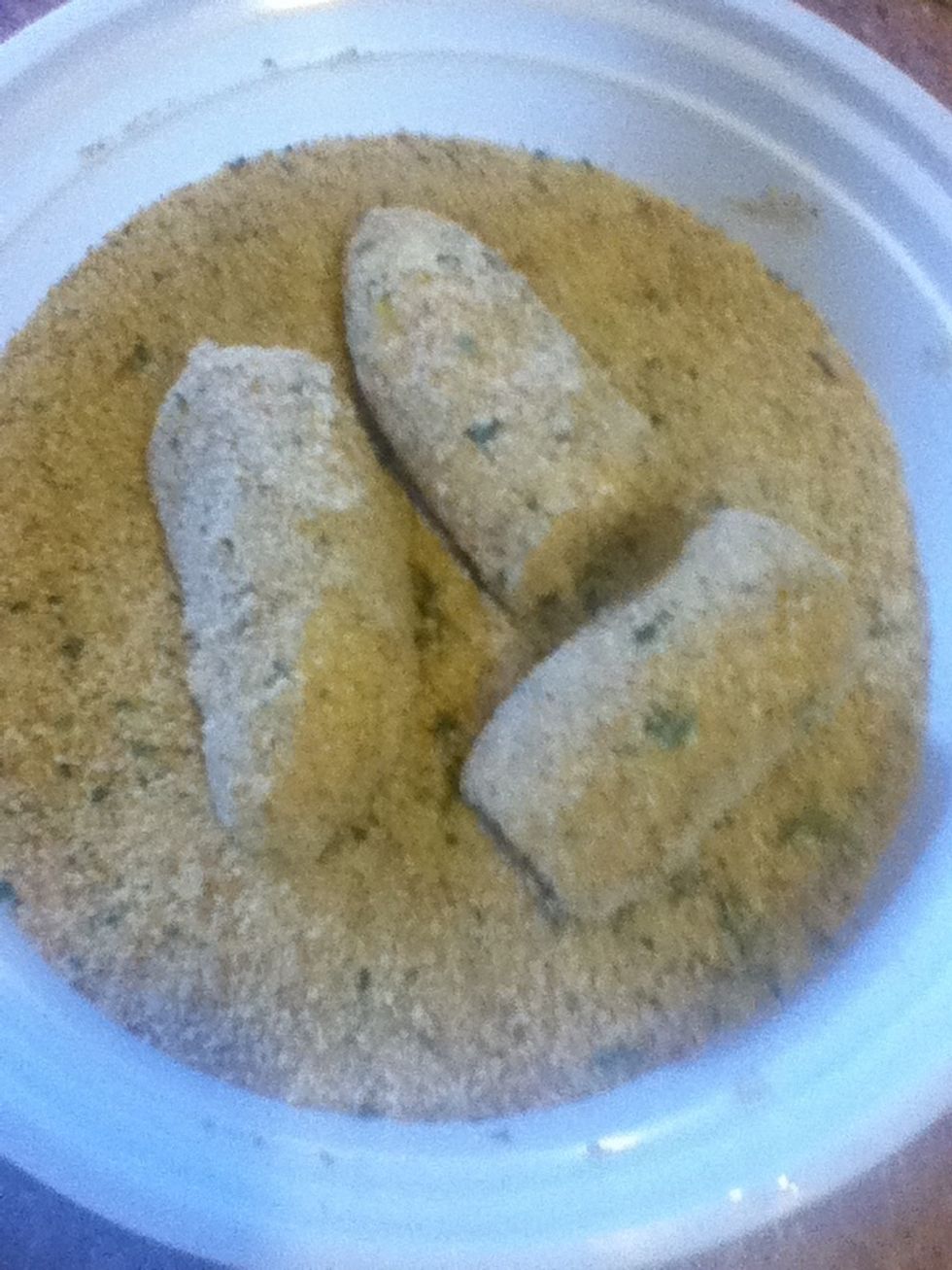 Next add the breadcrumbs after dipping with the egg and water