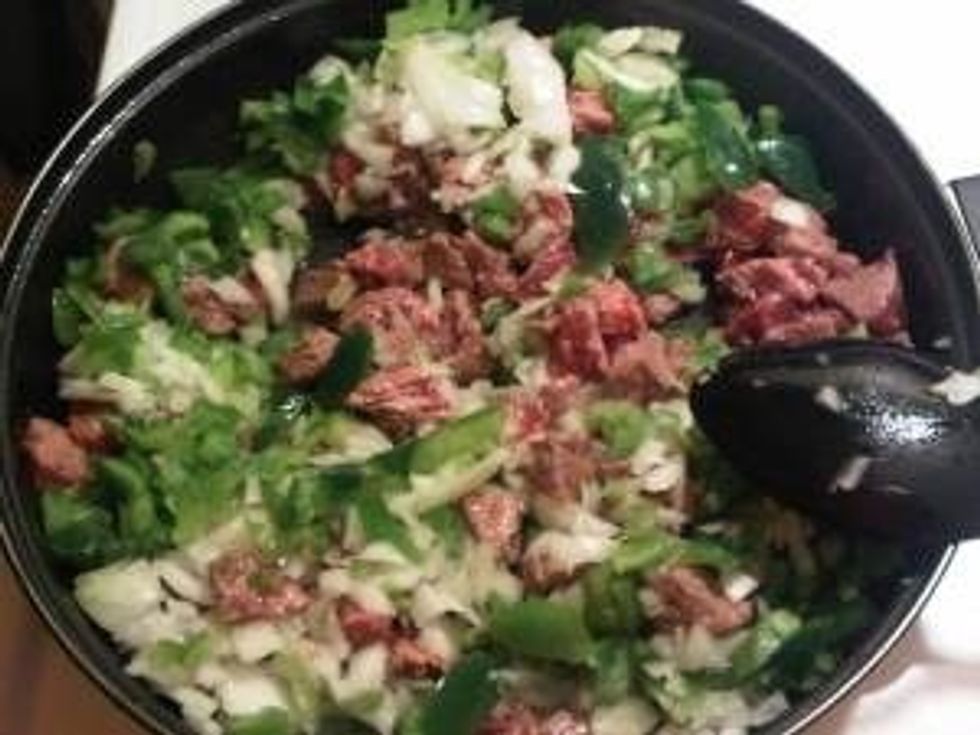 Next add the green peppers and onions and cook until meat is no longer pink on the outside and onion is softened.  I cook it for about another 2-3 minutes.