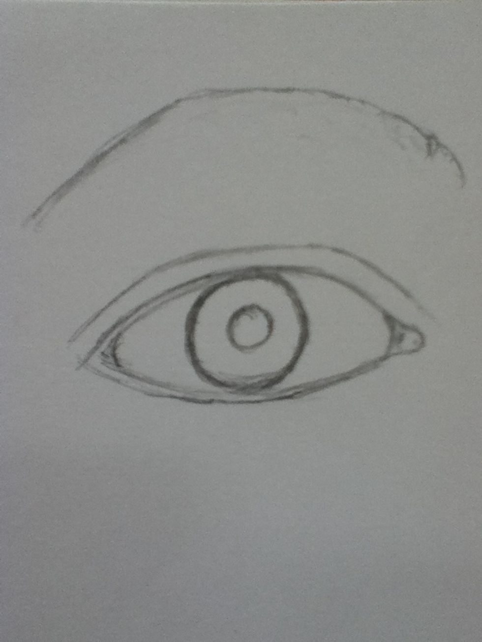 Next add the iris and pupil, the iris is the dark line around the cornea, and the pupil is the black section on the inside. This eye has a larger cornea that is completely shown, none is hidden.