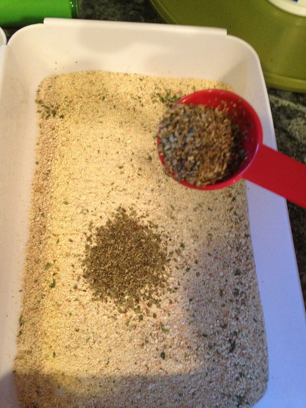 Next add the Italian bread crumbs to another bowl and to the breadcrumbs add the dried basil