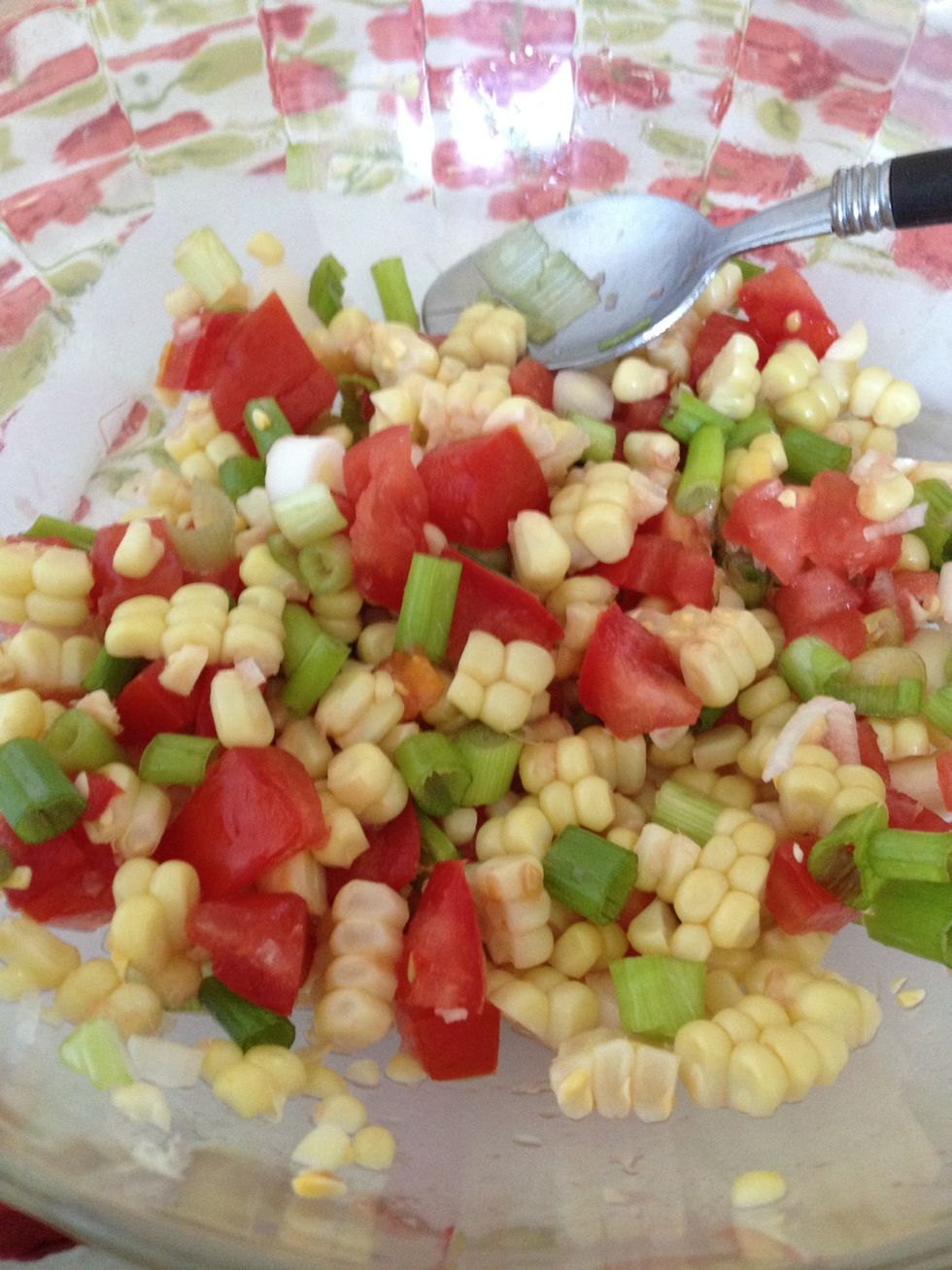 Next add the onion to the tomatoes and corn.
