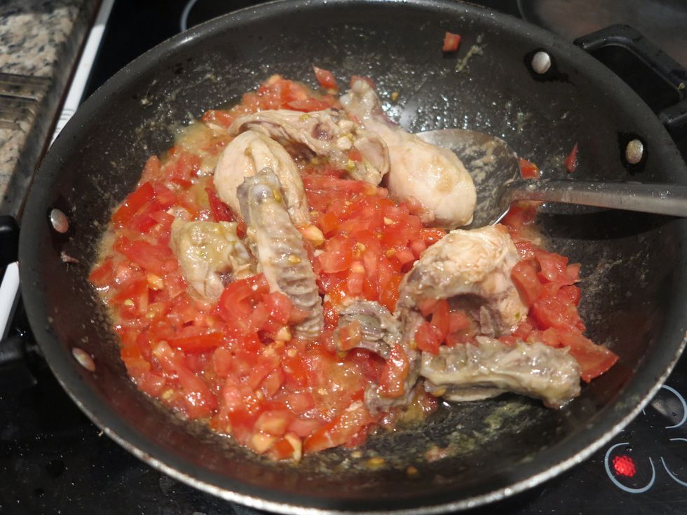 Next, add the tomatoes and stir thoroughly.