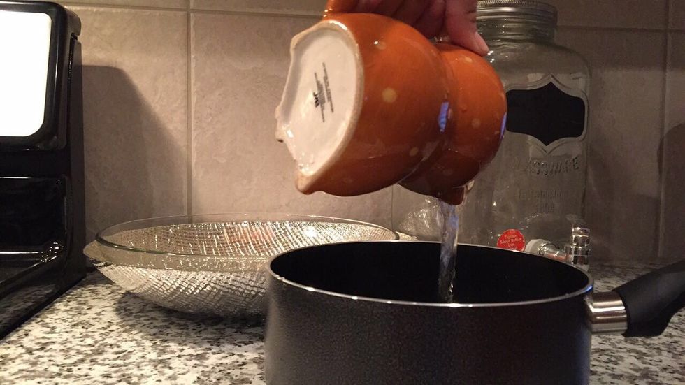 Next add the water into a small cooking pot