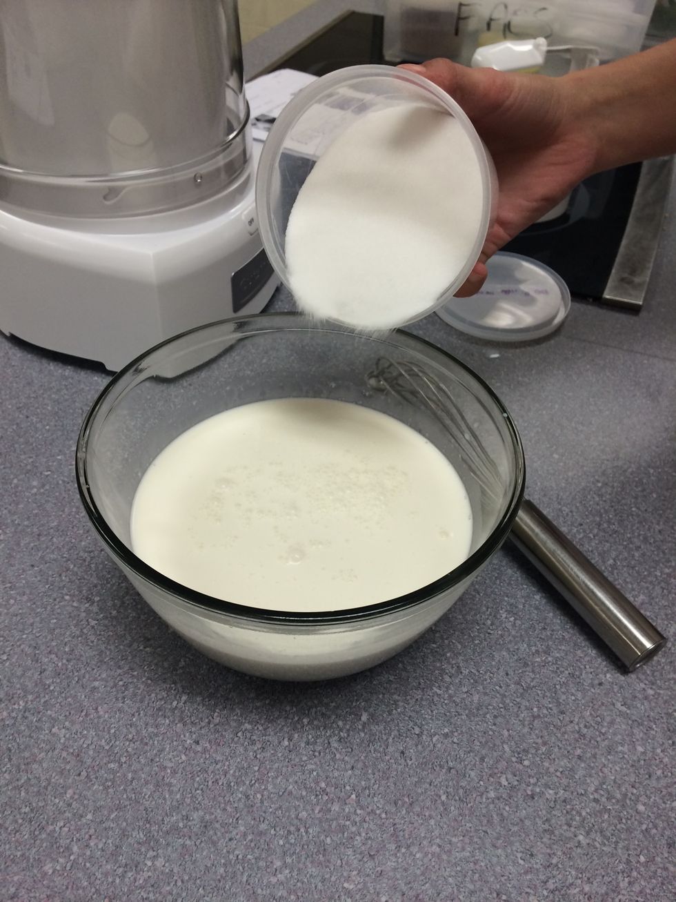 Next, add your peppermint and vanilla extract, sugar, and salt. The mixture will still be white, but you will be able to smell the extracts. Mix until all the sugar has dissolved.