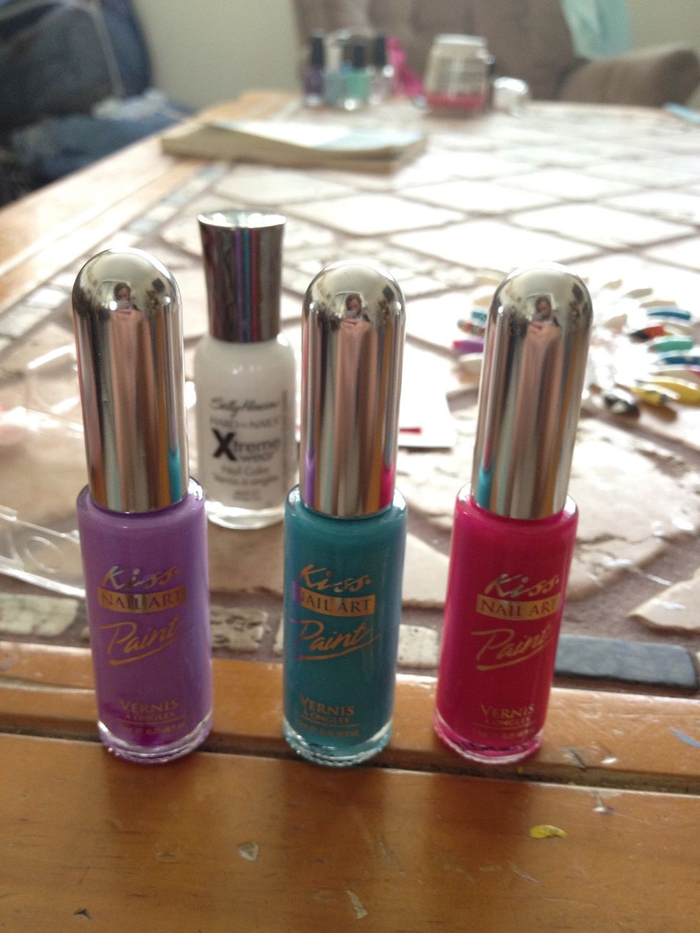 Next after your white nail polish completely dries, apply any 3 different nail polish. I used Kiss nail art, you can get it at CVS.