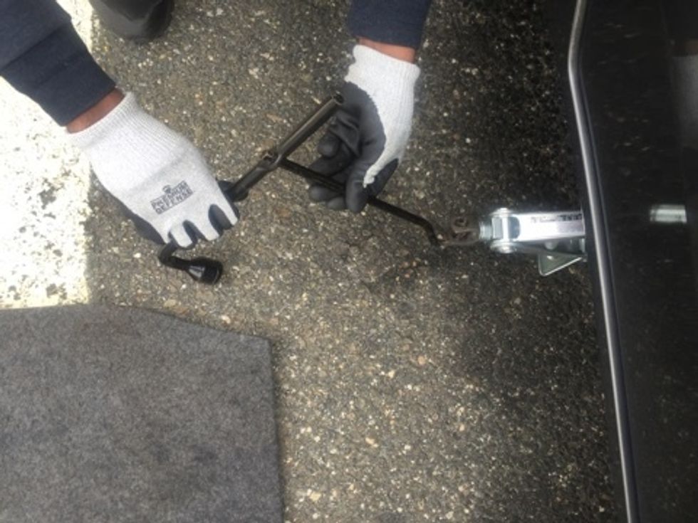 Next attach the lug nut wrench to the Jack arm assembly.