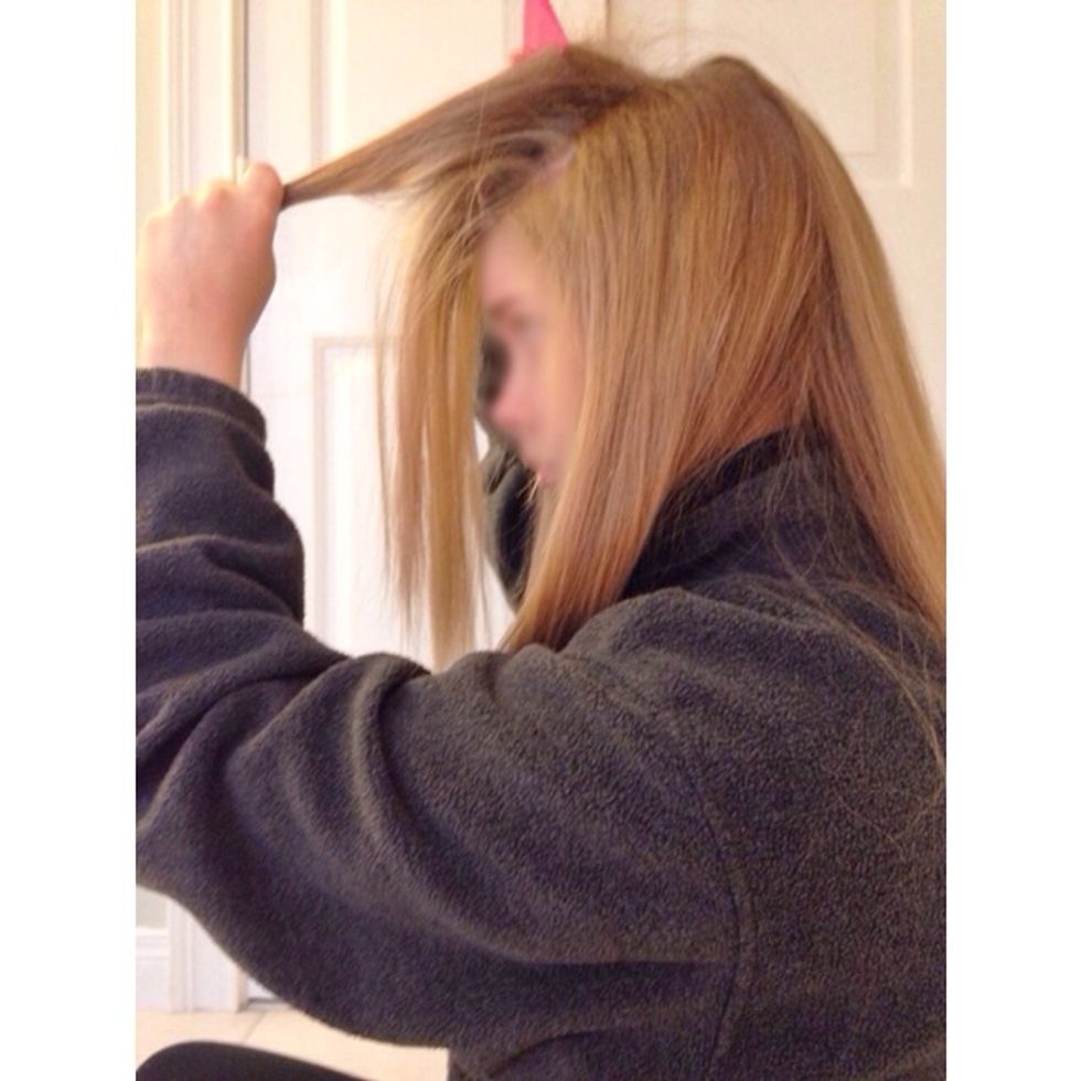 Next, begin teasing the hair you gathered from the front of your head.