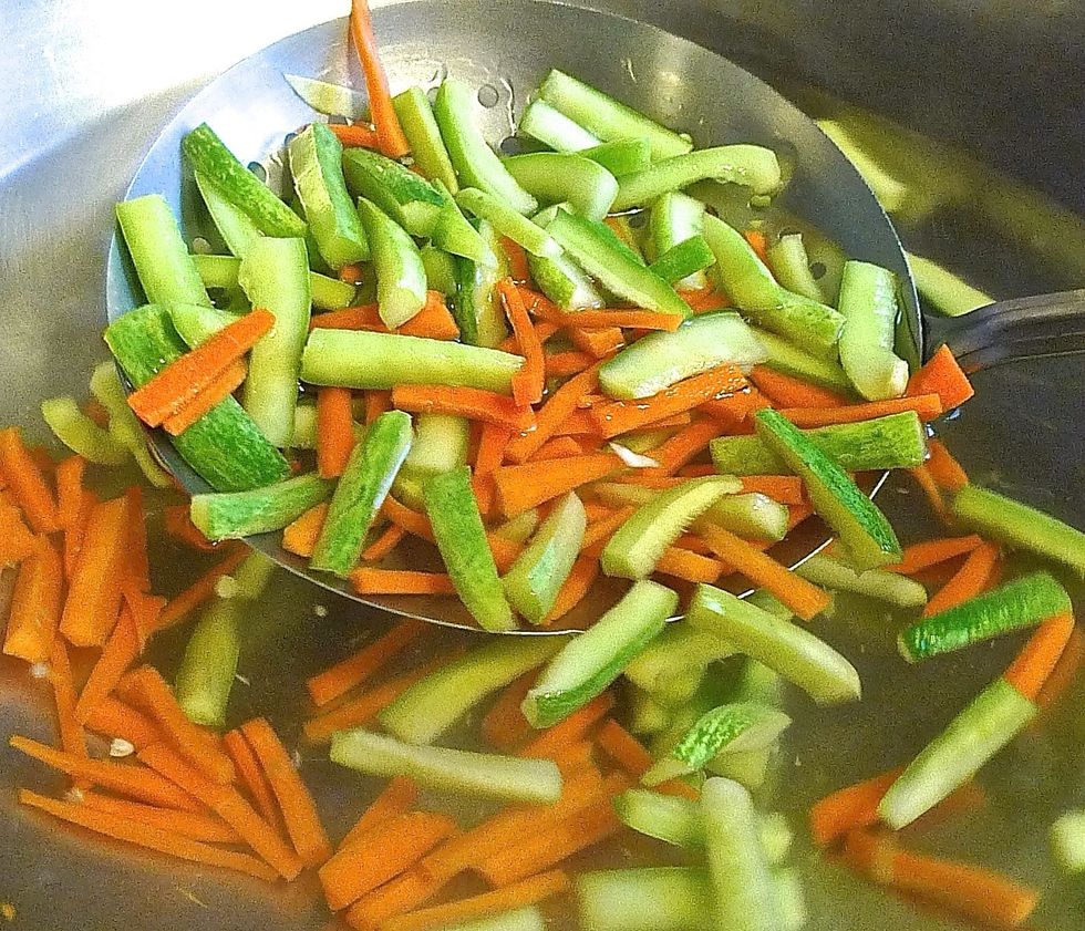 Next blanch the squeeze cucumbers and carrots.