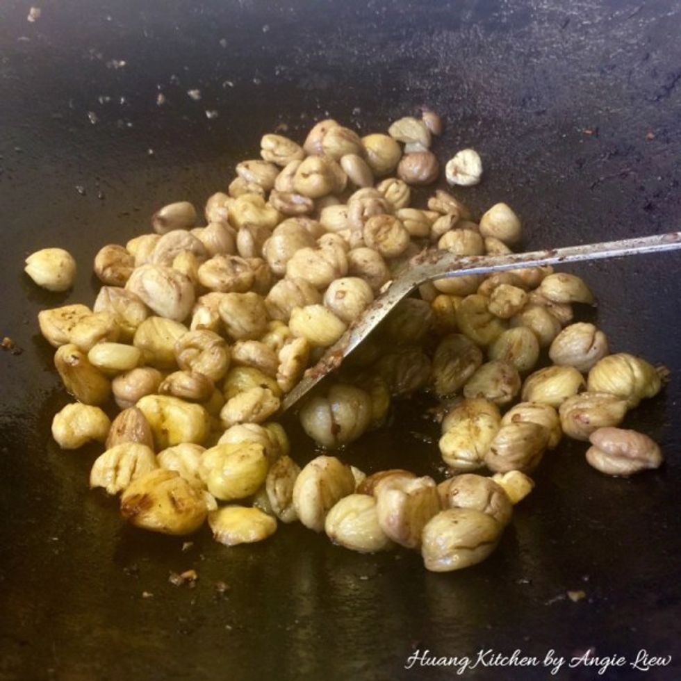 Next briefly stir fry the pre-soaked chestnuts and set aside.