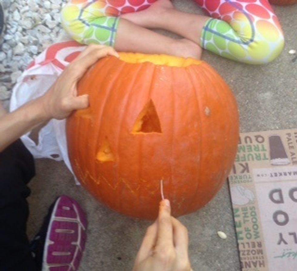 Next carve the pumpkin face.
