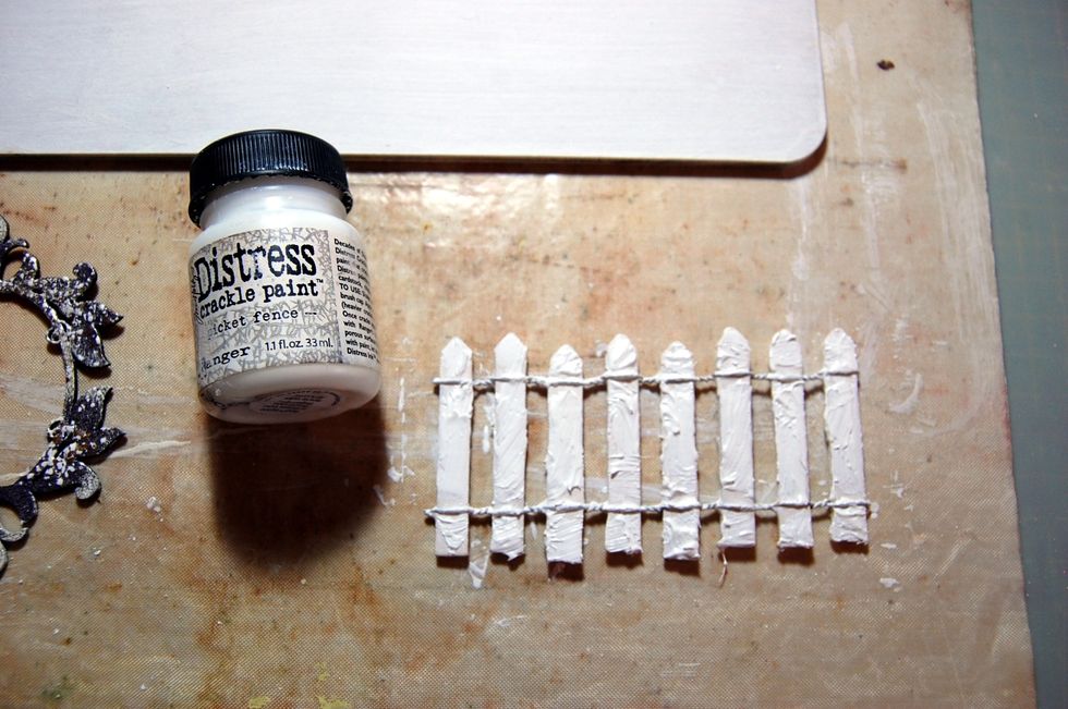 Next choose some main pieces to add to your plaque design. Cover the picket fence with a coat of Distress crackle paint 'picket fence'