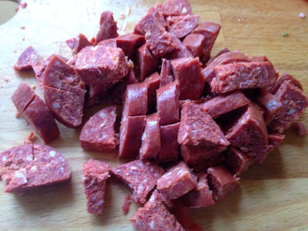 Next chop your ready cooked sausage. I'm using a spicy Turkish sucuk which is like a beef chorizo And add to to the veg pan. TIP: if you prefer a crunchier sausage, don't add it yet...