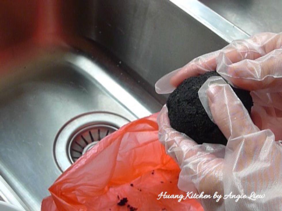 Next, clean salted egg by first removing the black charcoal from the egg. Then rinse egg under running water.