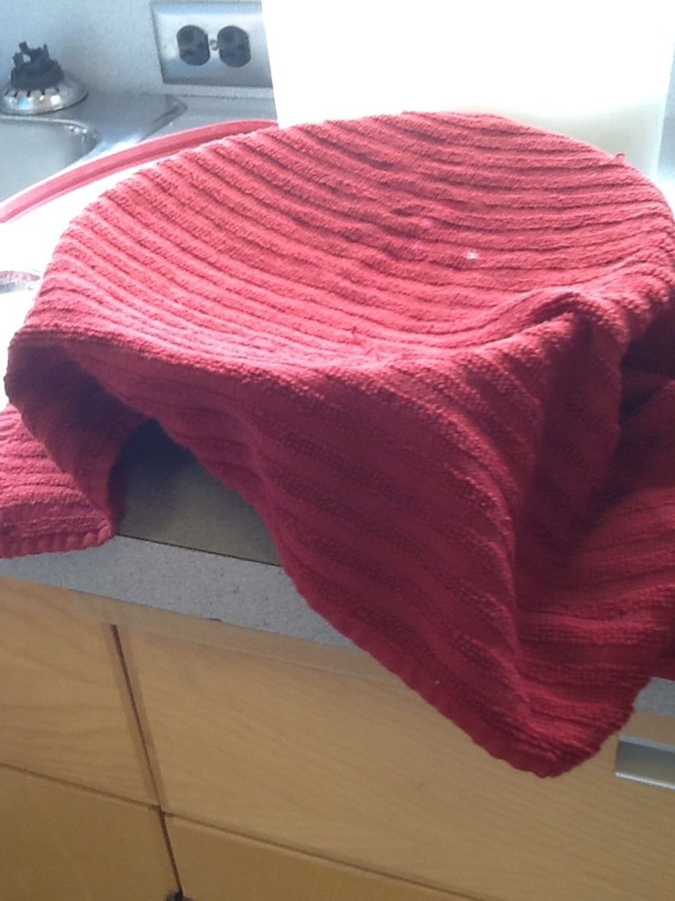 Next, cover the bowl with a cloth and let it sit for 5-10 minutes until the yeast activates and turns into foam on top of the water.